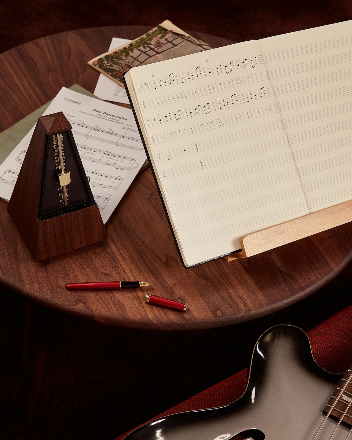 Musical instruments and sheet music rest on a wooden table.