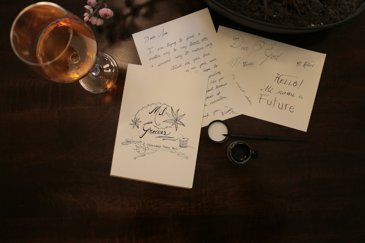Handwritten notes and a drink on a wooden table.